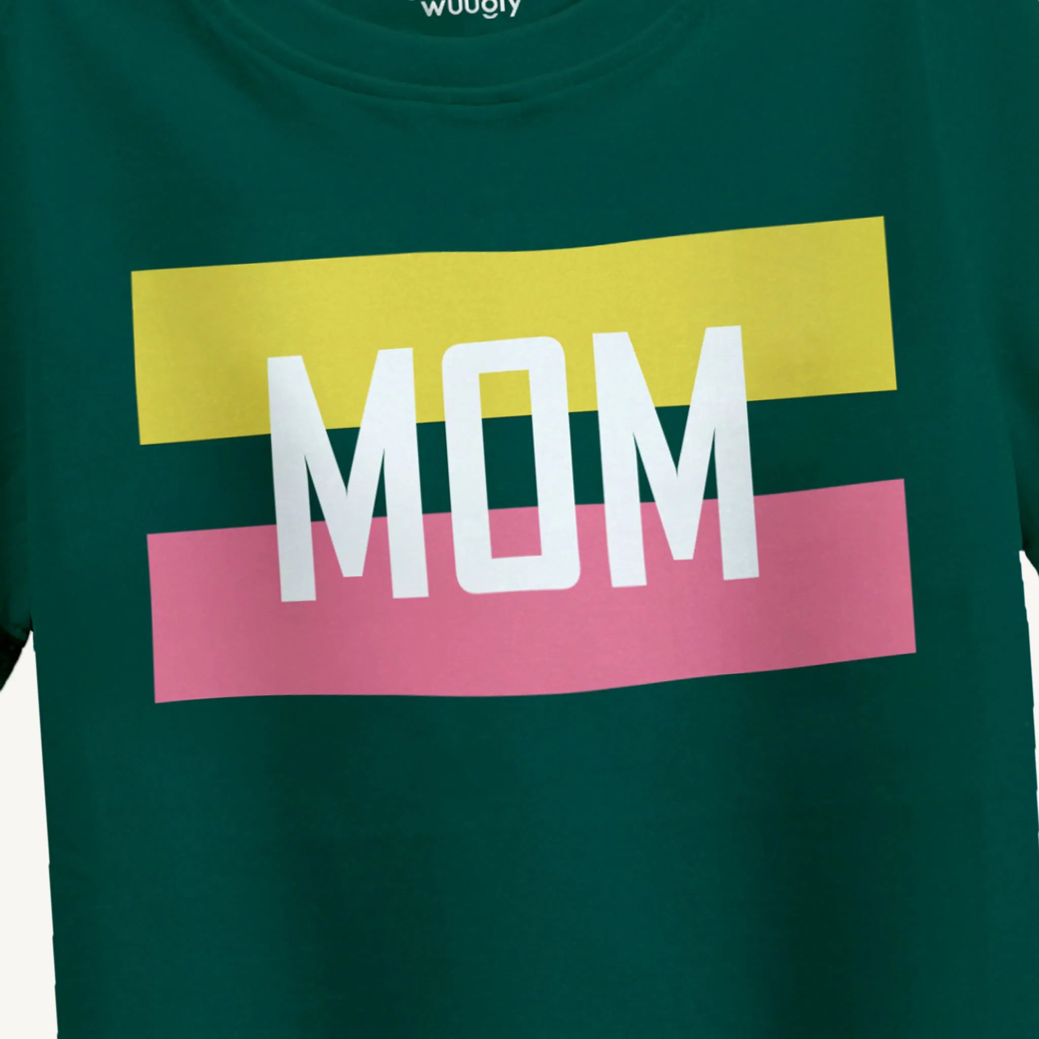 Closeup of 'Mom' print design on boys' green T-shirt with yellow and pink stripes behind it, ideal for ages 4-12 years.